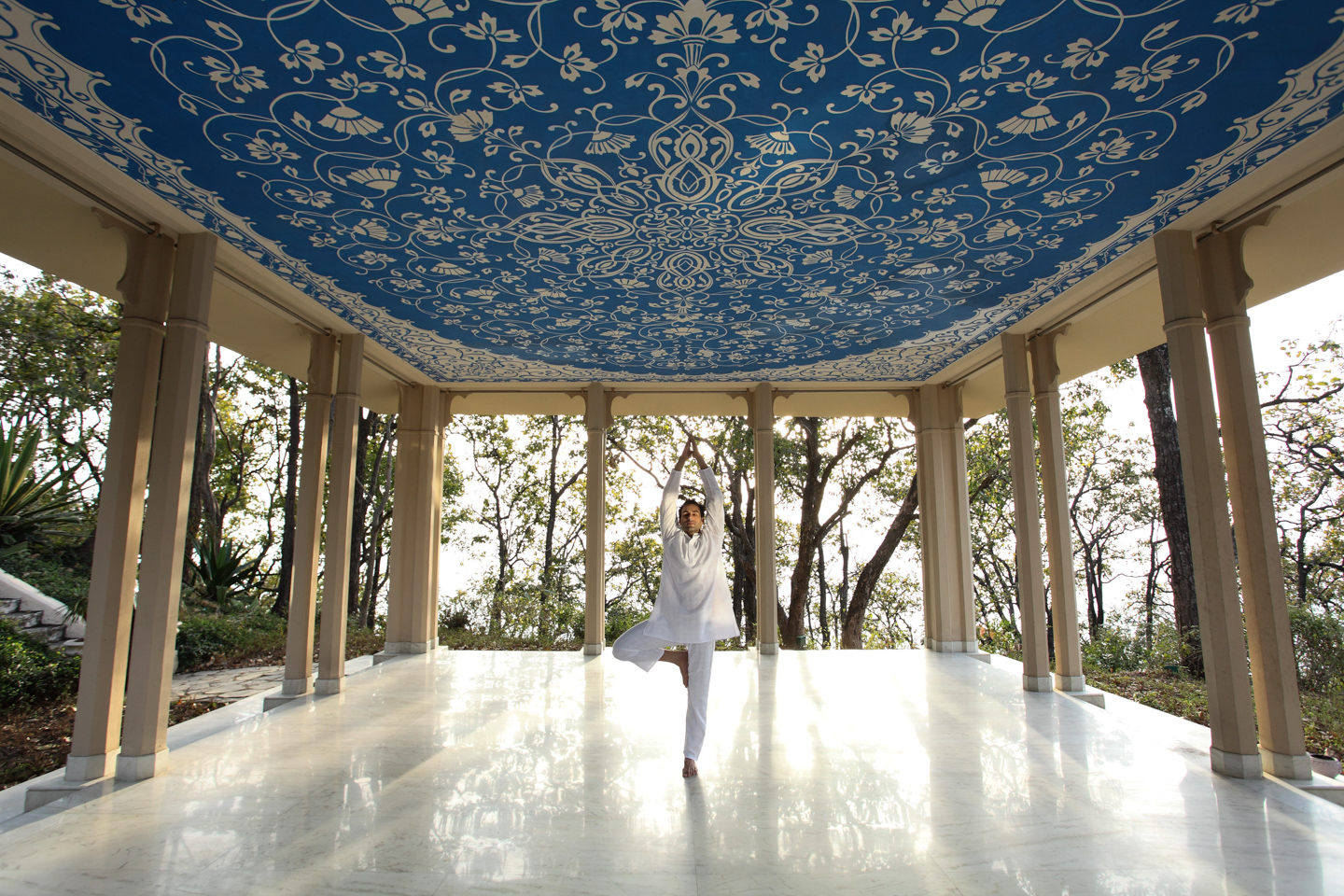 A man performing yoga in the pavilion.
