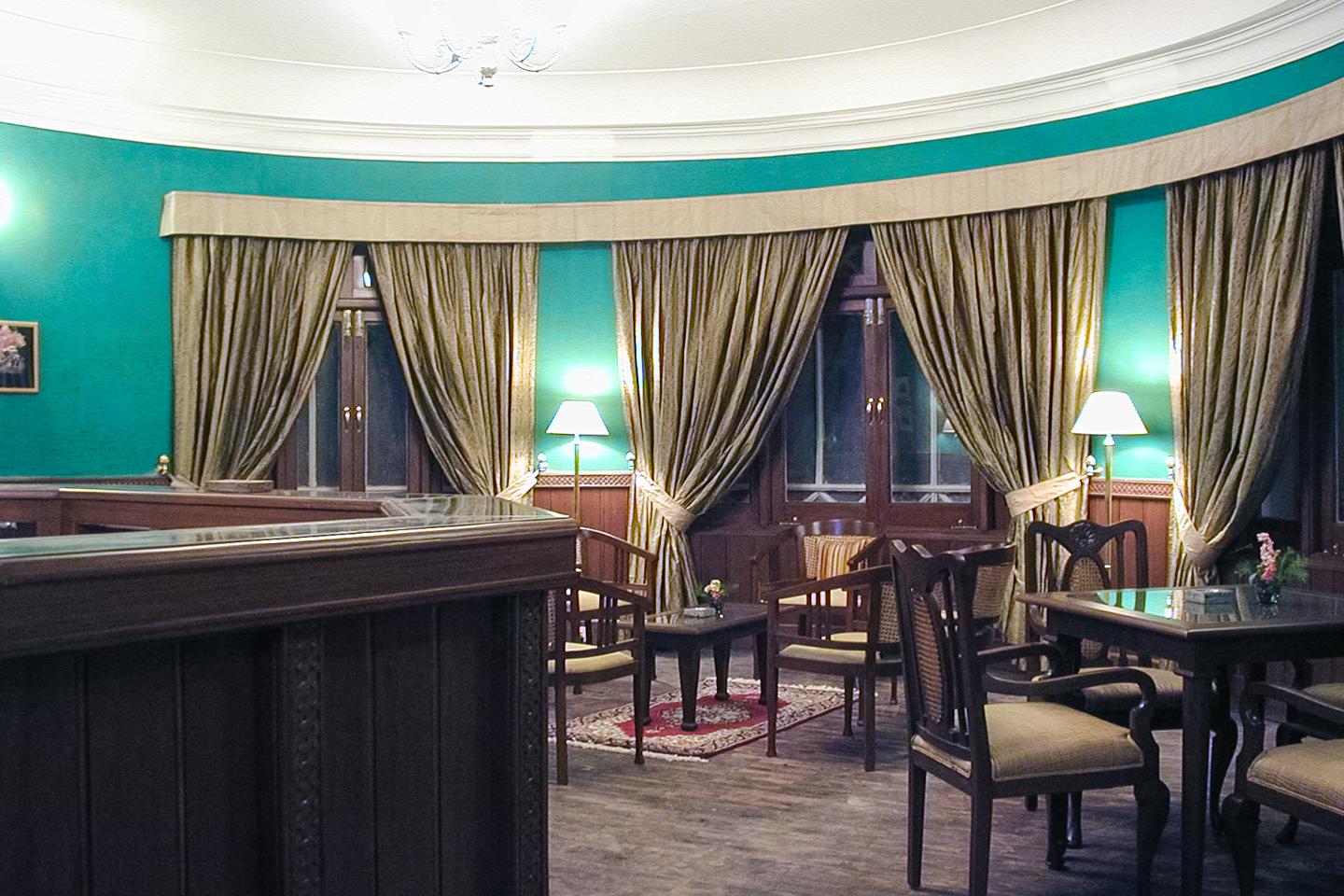 The bar has wood panelling and deep green walls.