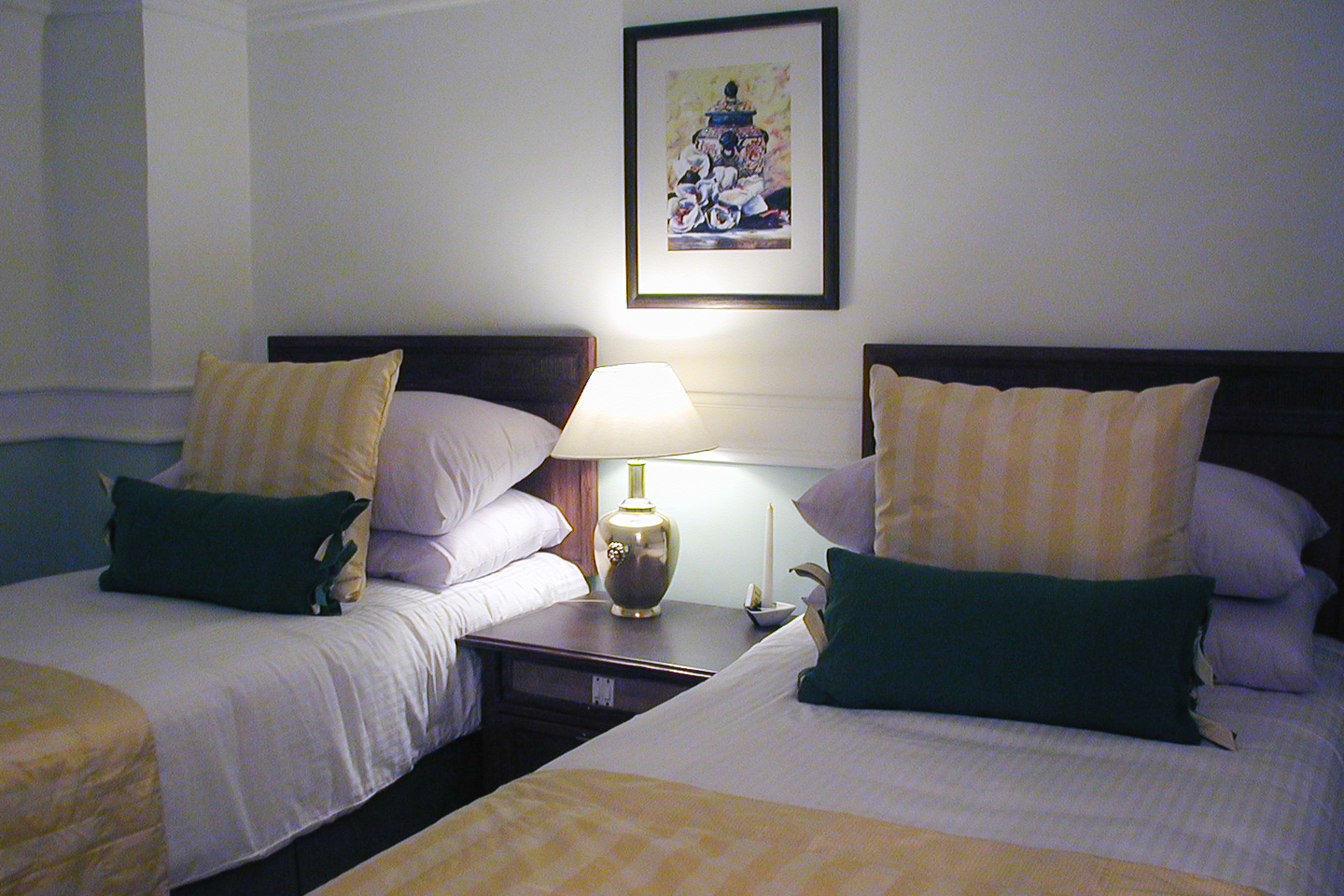 The green guest room has pale green walls with white highlights.
