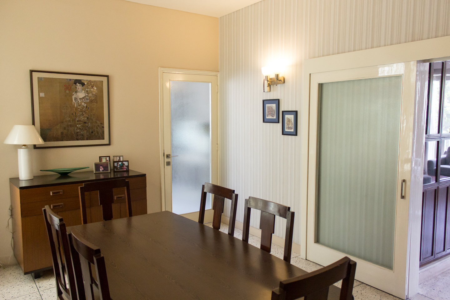 The dining room with frosted glass doors leading to the kitchen and drawing room.